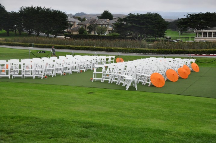 mango colored parasols lined the outer aisles of the ceremony